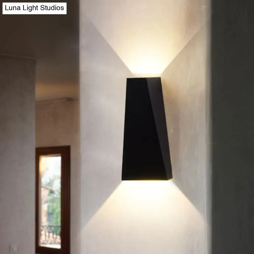 Modern black nord wall sconce with geometric design serving as a sleek bedroom wall lamp in black and white