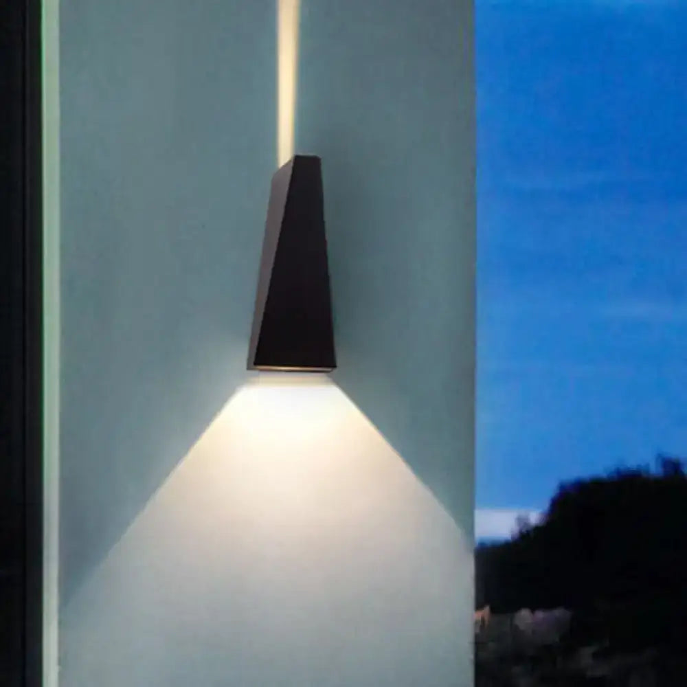 Modern black nord wall sconce with sleek angular design casting warm light downward for bedroom wall lamp use