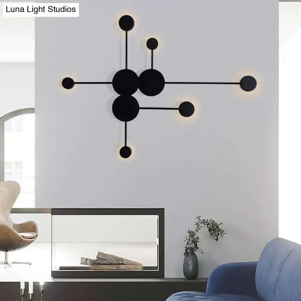 Modern black wall sconce light fixture with geometric circular design and warm ambient lighting for living room wall light