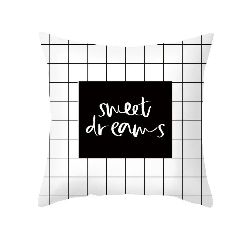 White throw pillow with black grid and central black square featuring sweet dreams in white cursive for home decor decorbites black geometry letters