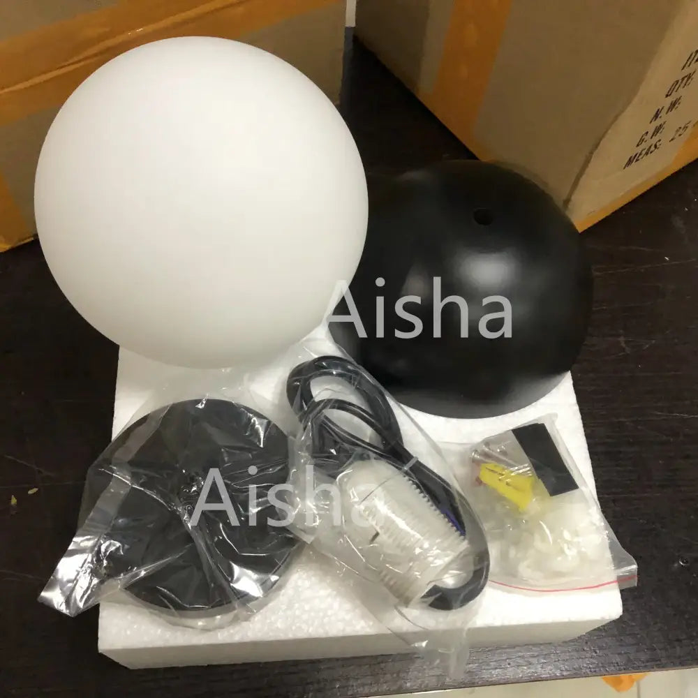 Modern black and white decorbites glass ball pendant lights featuring white frosted glass globe and black base with hardware