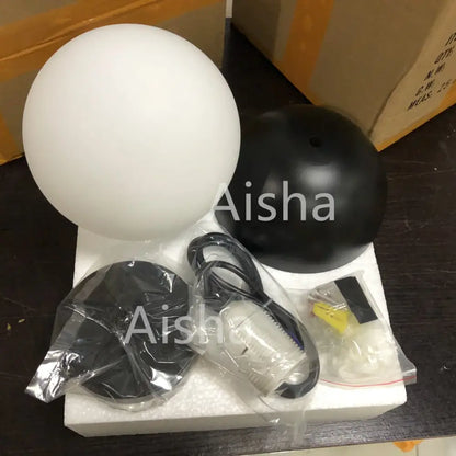 Modern black and white decorbites glass ball pendant lights featuring white frosted glass globe and black base with hardware
