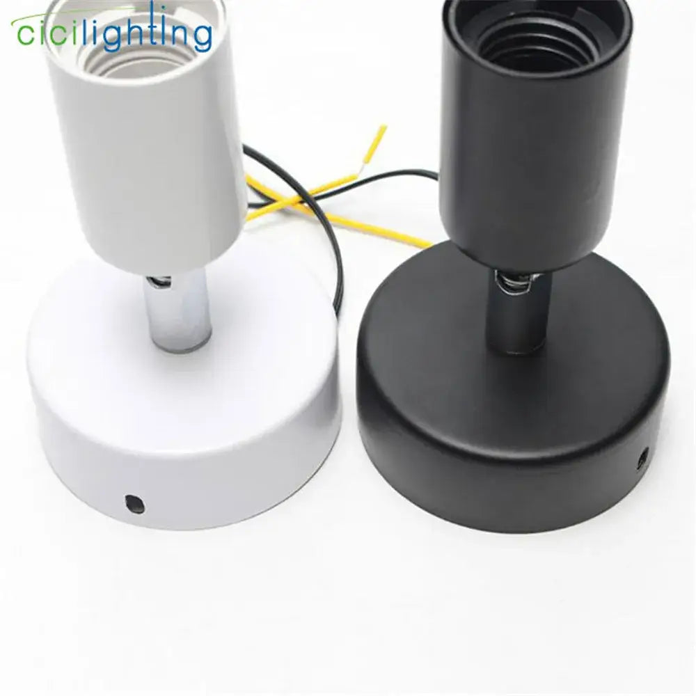 Two cylindrical lamp sockets in black and white with threaded tops for bulbs in decorbites industrial ceiling light