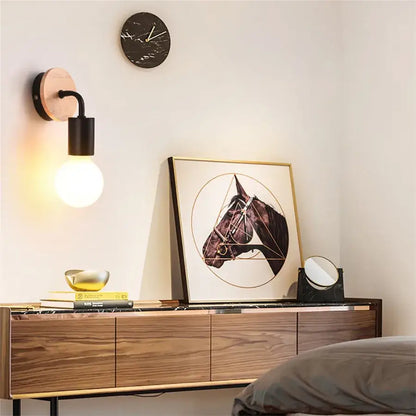 Modern black and white iron art wall light with round wooden backplate and exposed bulb iron art wall sconce decorbites