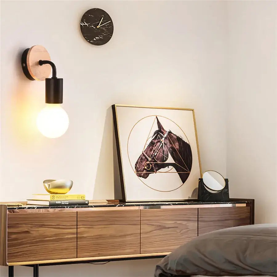 Modern black and white iron art wall light with round wooden backplate and exposed bulb iron art wall sconce decorbites