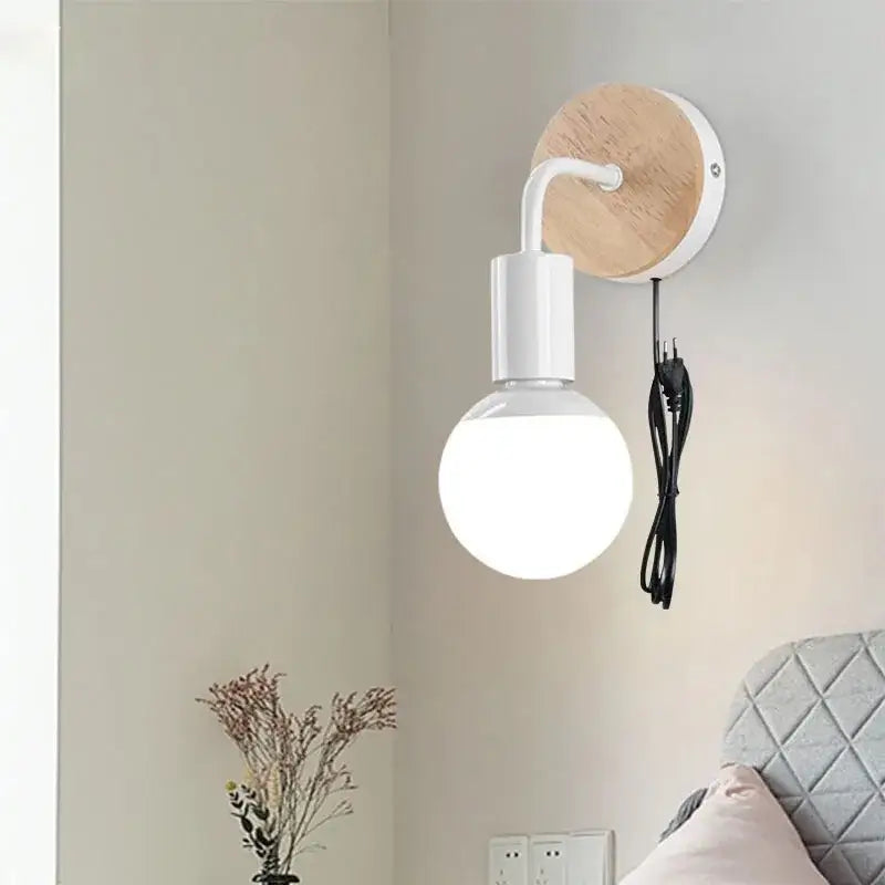 White wall light with round wooden backplate and spherical bulb from decorbites iron art wall collection