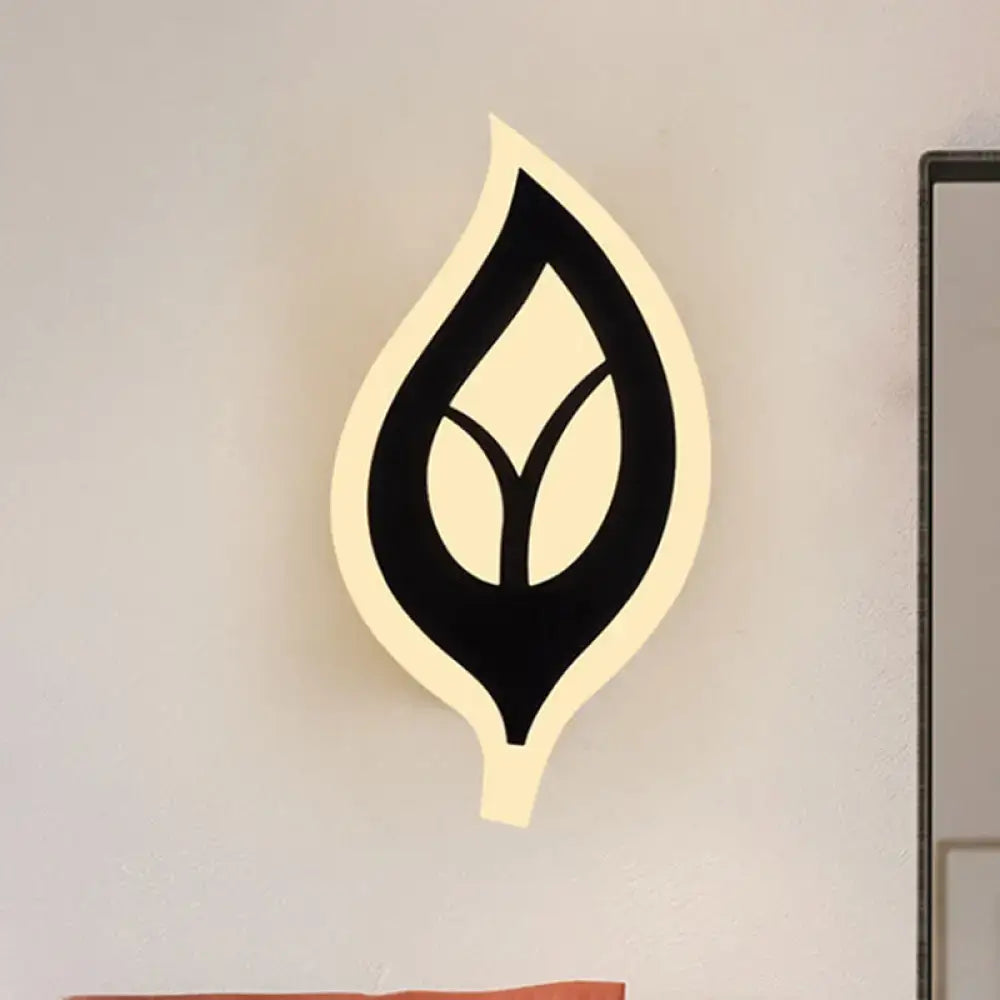Modern black white leaf sconce light with sleek design and warm illuminated outline for bedroom wall lamp use