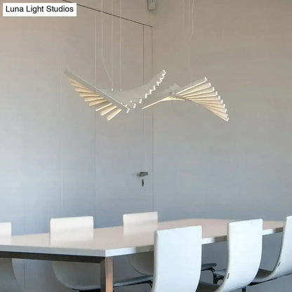 DecorBites™ modern led chandelier featuring a sleek white bird-shaped pendant with layered wing panels above dining table