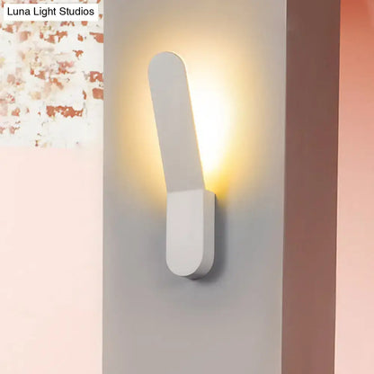 Modern black and white led lighting oval shape corridor wall sconce with a sleek white minimalist rectangular design emitting warm light
