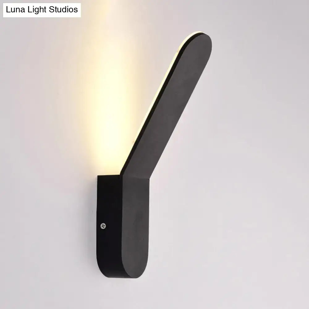 Modern black and white oval shape led lighting wall sconce with sleek angular design emitting warm light for corridors