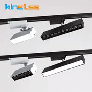 Modern black and white led linear grille track spotlights with adjustable heads mounted on a sleek black rail system