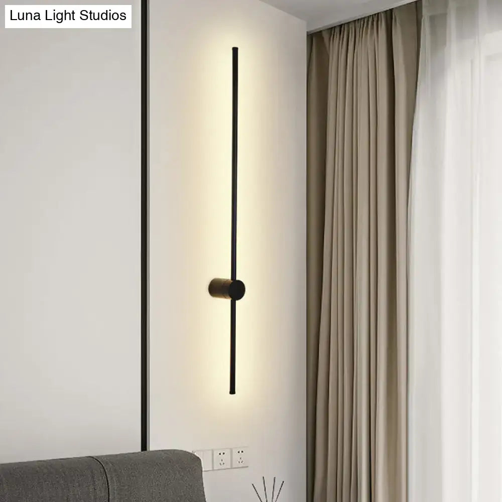 Modern black led metal wall sconce with sleek vertical bar and cylindrical base for indoor lighting in living room