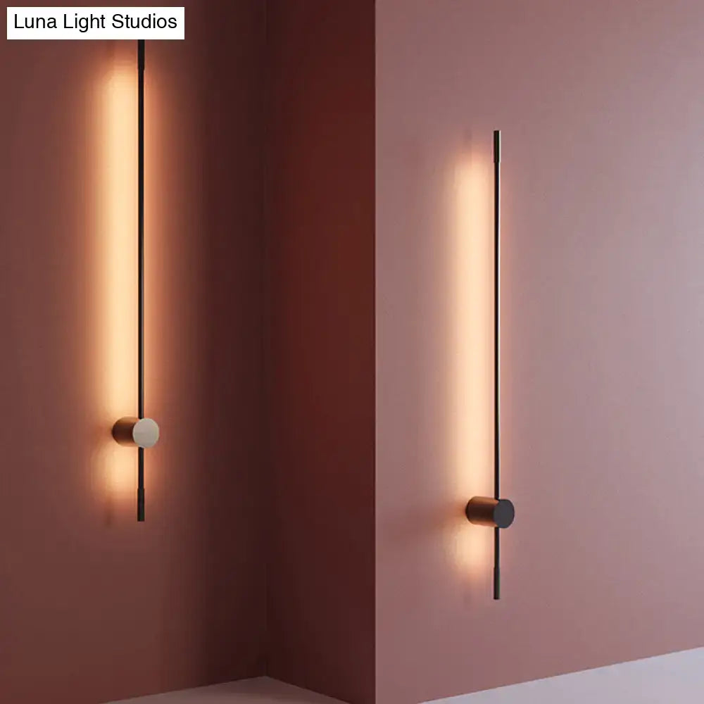 Modern black and white led metal wall sconce with warm linear light strip for indoor lighting in living room