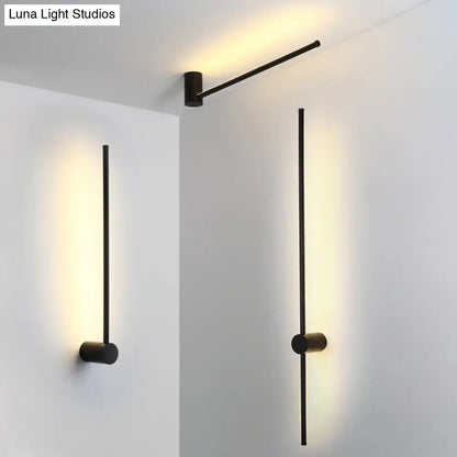 Modern black and white led metal wall sconce with slender rods and cylindrical bases for indoor lighting use