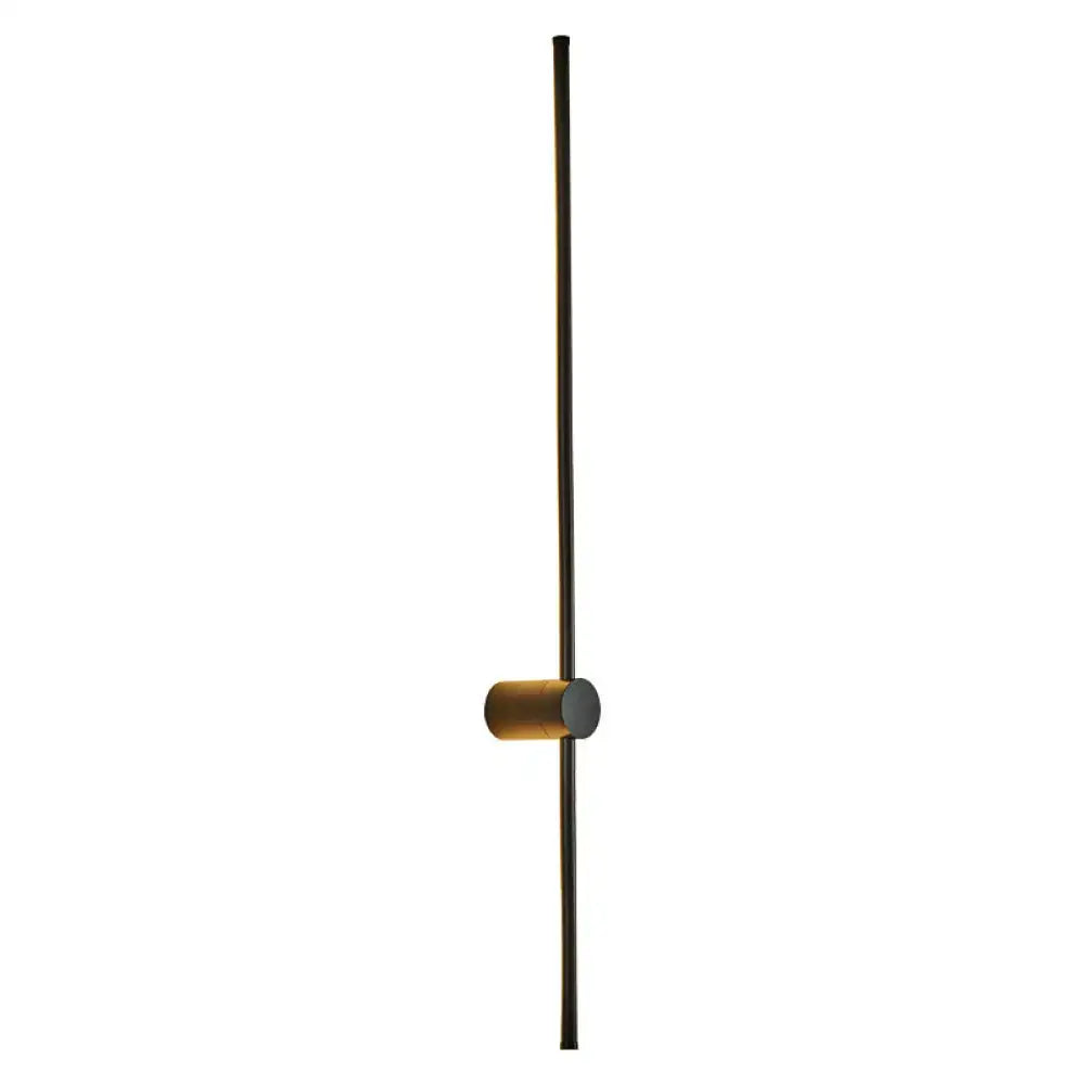 Minimalist modern black and white led metal wall sconce with slender black rod and brass accent for indoor lighting