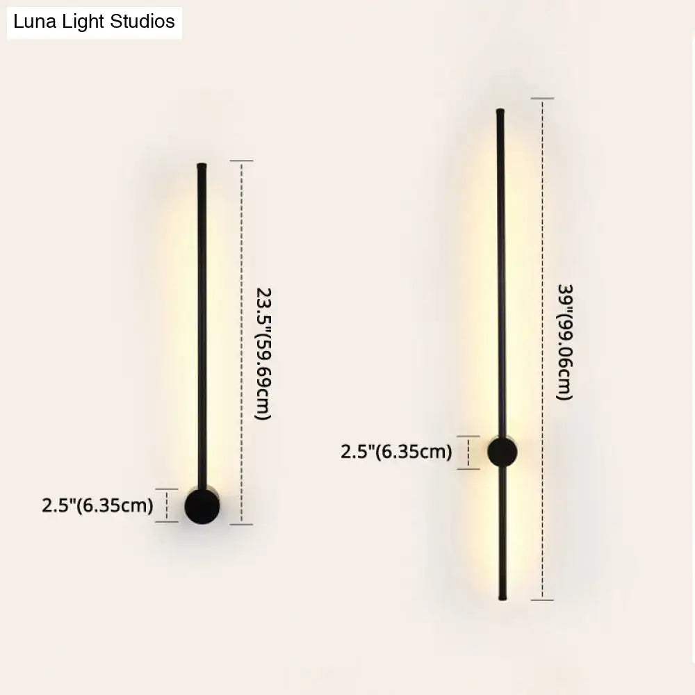 Modern black and white led metal wall sconce with sleek cylindrical design and warm indoor lighting for living room