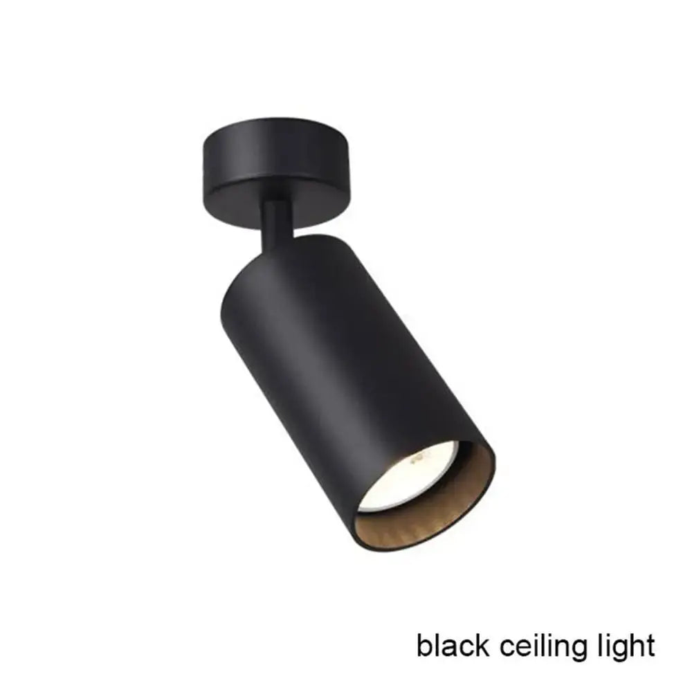 Modern black and white led track lamps featuring black cylindrical matte finish with warm-toned interior for clothing store decorbites black white