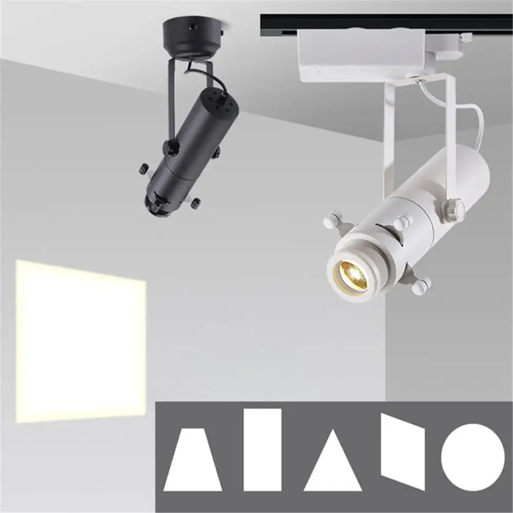 Modern black and white led track light with adjustable cylindrical bodies and articulated arms for gallery spotlight use