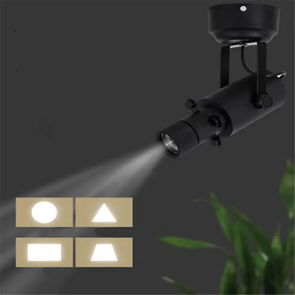 Modern black and white led track light featuring a black cylindrical spotlight with adjustable focus for accent lighting
