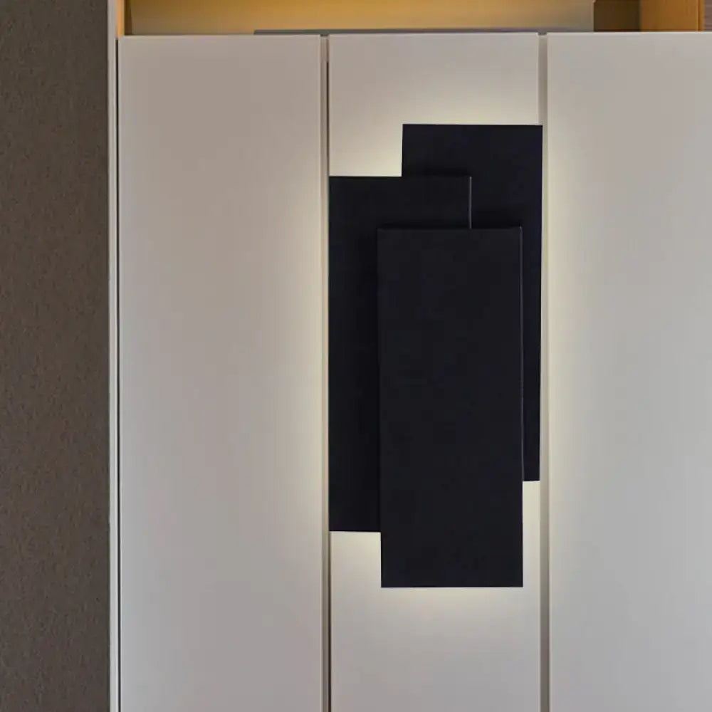 Modern black wall lamp with layered geometric design and fixture height of 5in for black white bedroom lighting