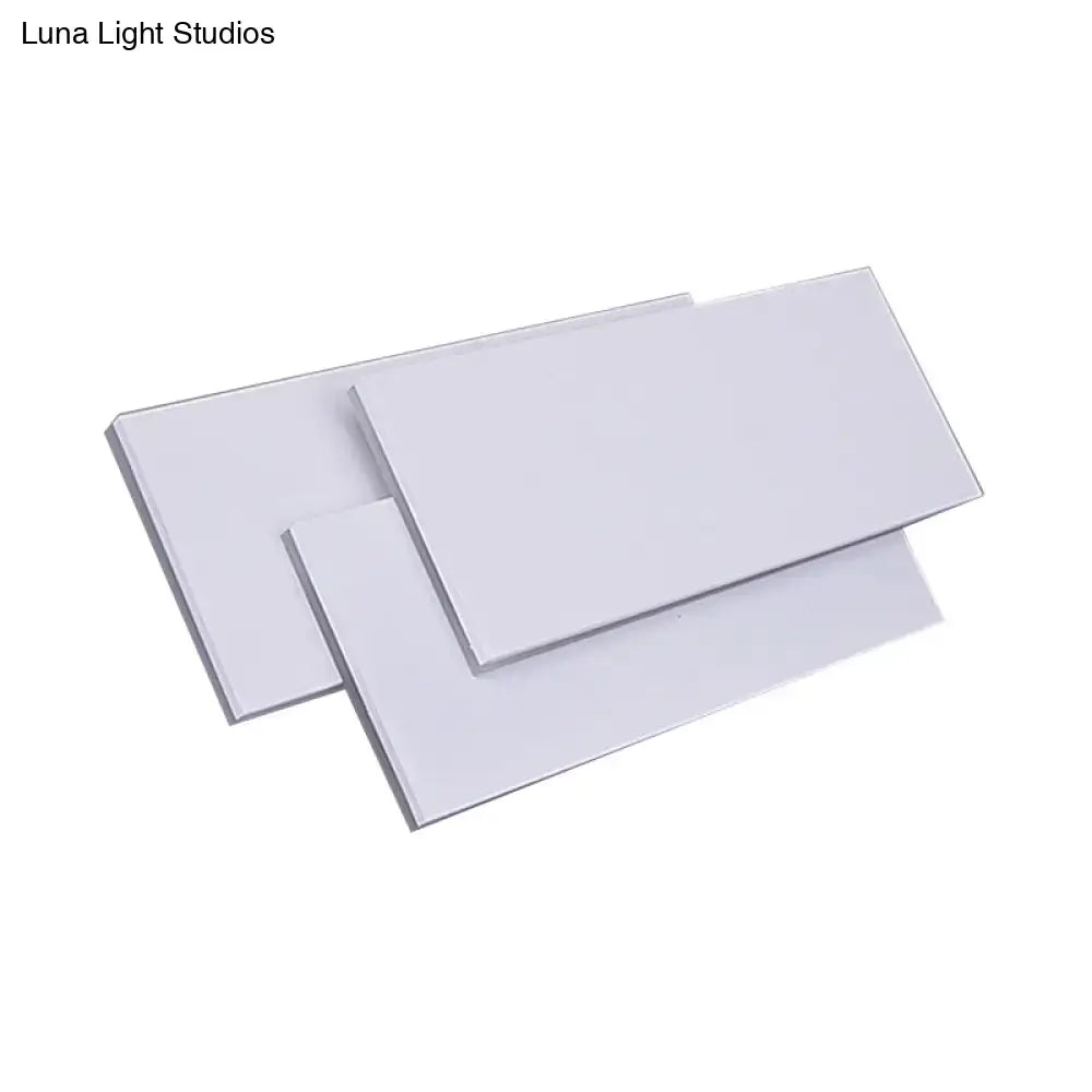 Three sleek white acrylic panels with glossy finish on modern black white led wall lamp fixture height 5in