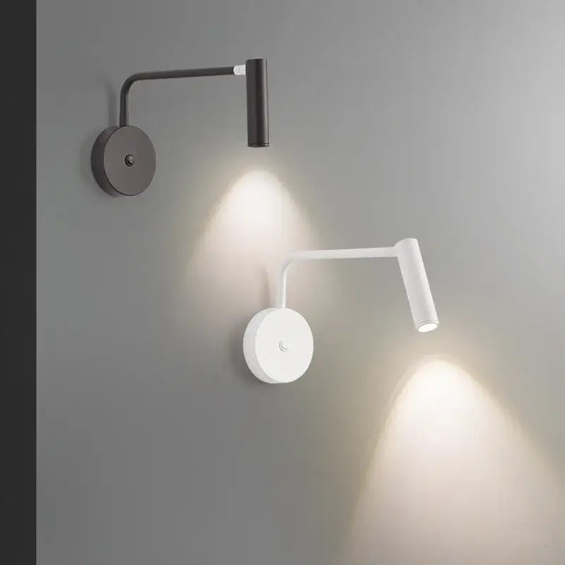 Two modern adjustable black and white decorbites led wall lamps with circular base and switch for bedroom lighting