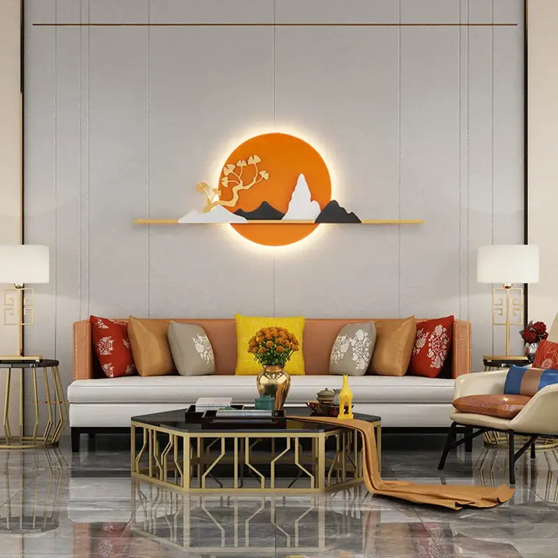 Modern black and white led wall lamp featuring orange circular art with mountain silhouettes and gold branch design illuminated from behind