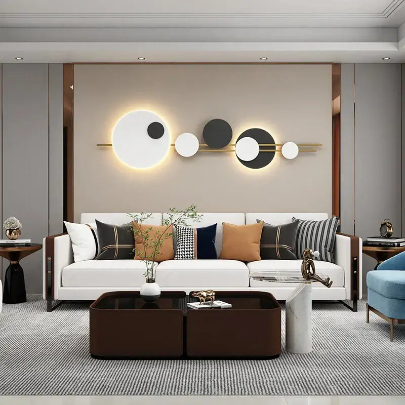 Modern black and white led wall lamps featuring geometric illuminated discs on a gold-toned bar for bedroom lighting