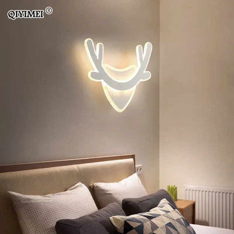 Modern black and white led wall lamp with deer head design and glowing white antlers for bedroom decor