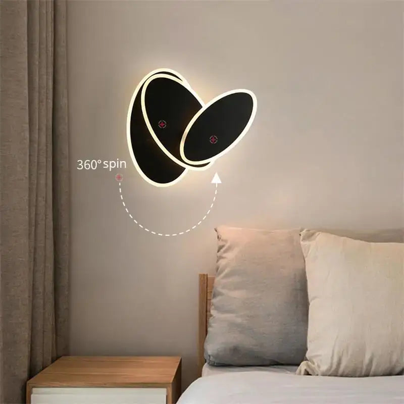 Modern black and white led wall lamps with a sleek oval design that spins 360 degrees for bedroom use