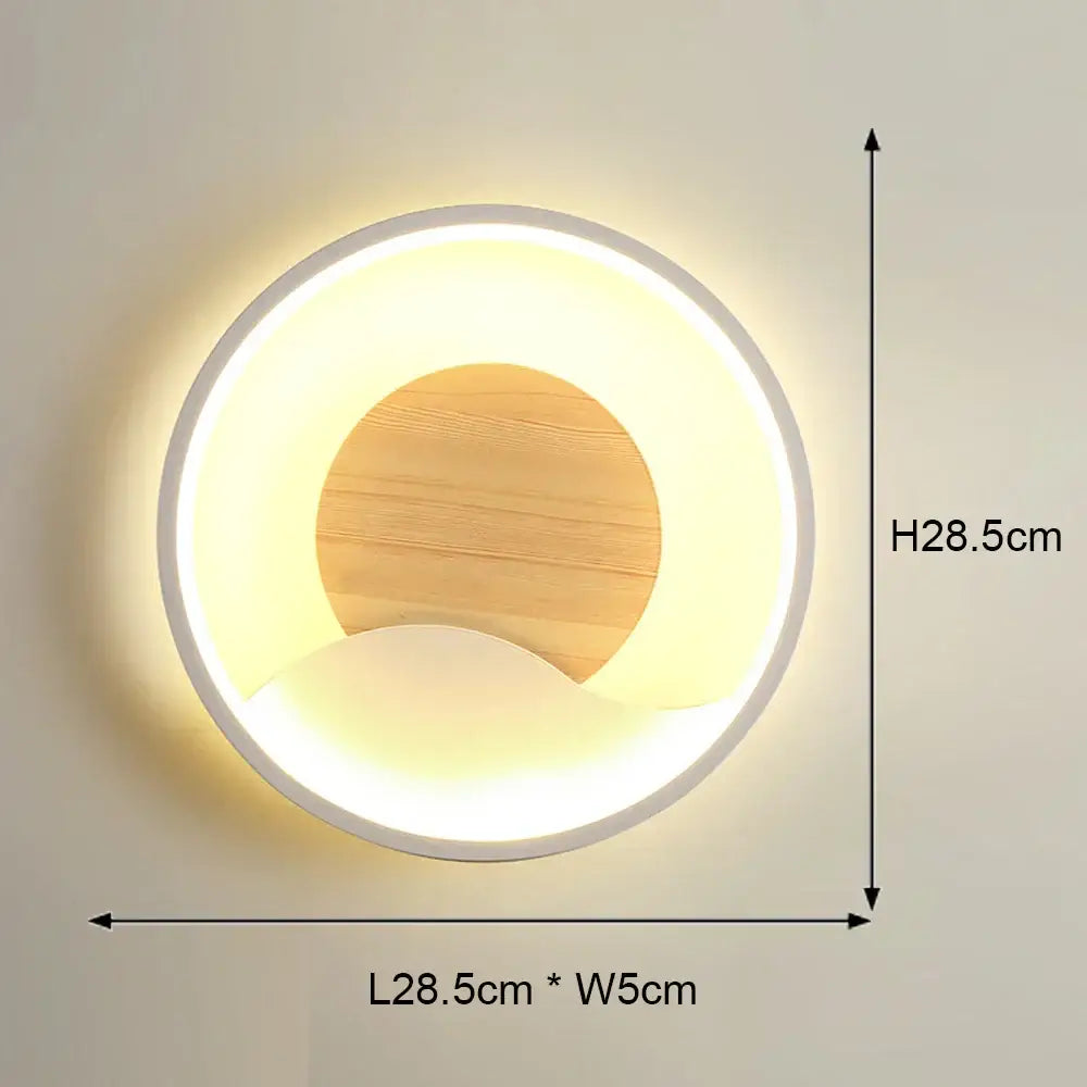 Modern black and white led wall light with a circular white frame and wooden panel glowing warm yellow illumination