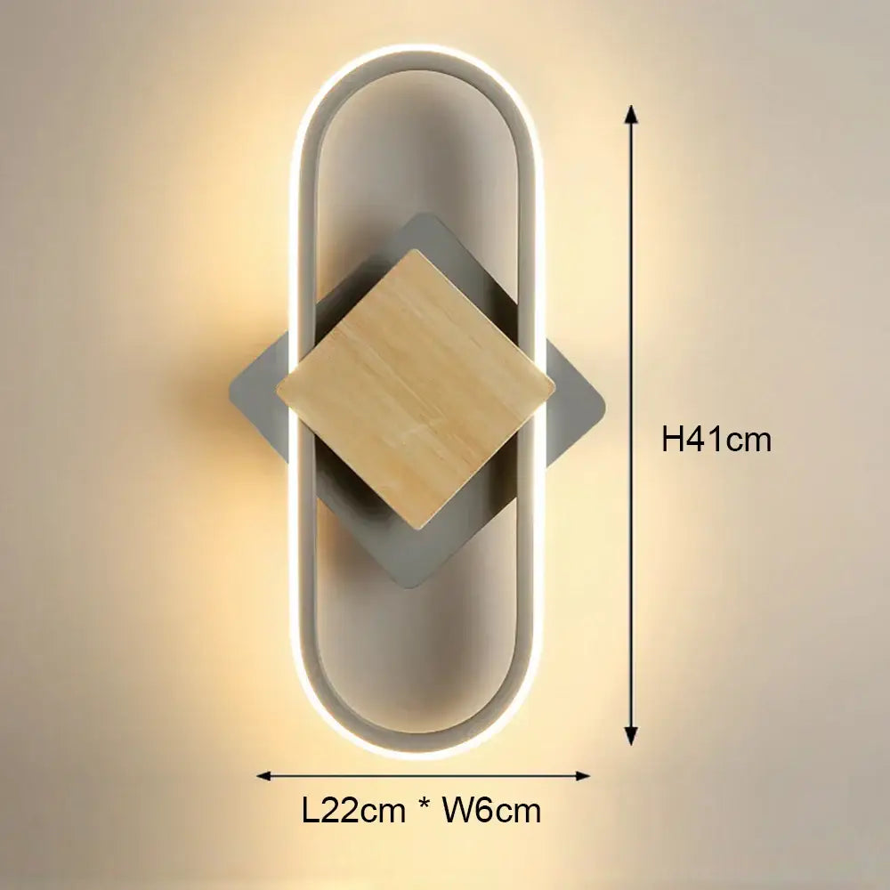 Modern black and white led wall light with sleek oval frame, glowing led strip, matte gray metal, and natural wood accents