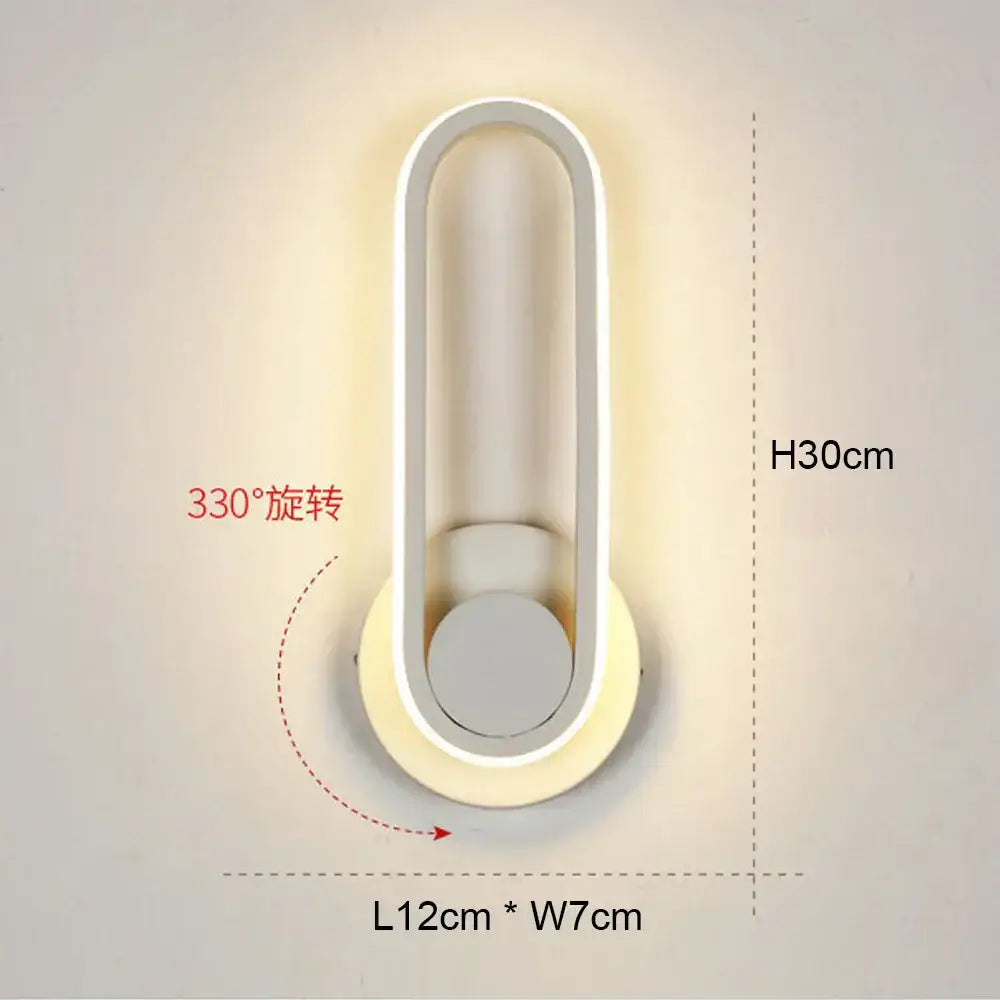 Modern black and white led wall light with sleek oval shape and 330-degree adjustable rotation for bedroom use