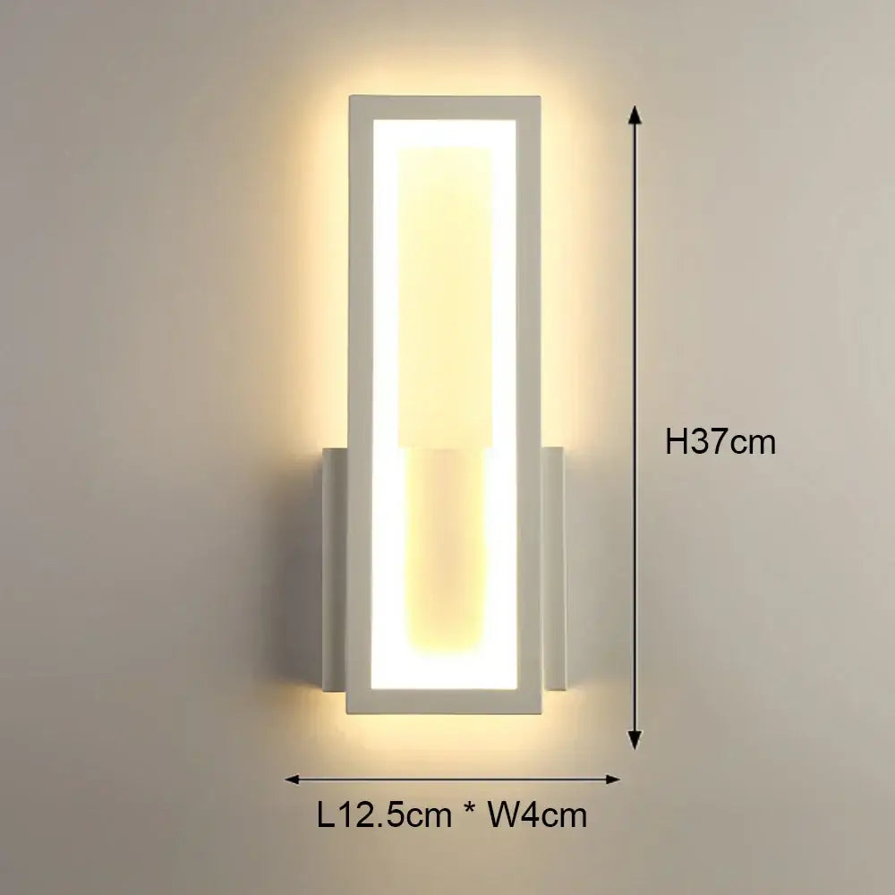 Modern black and white led wall light with a sleek rectangular design providing warm ambient lighting for bedrooms