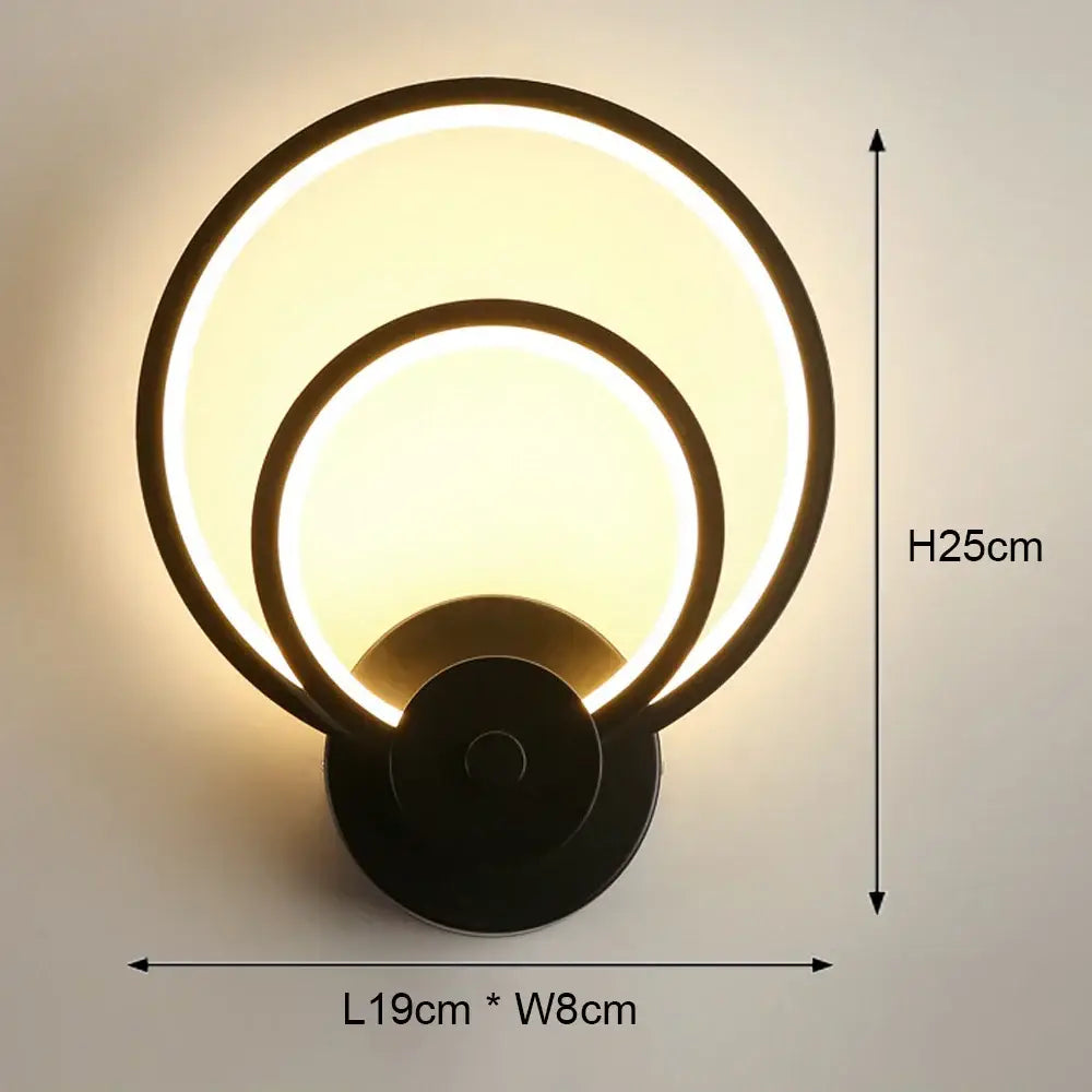 Modern black and white led wall light featuring a circular design with two concentric glowing rings for bedroom use