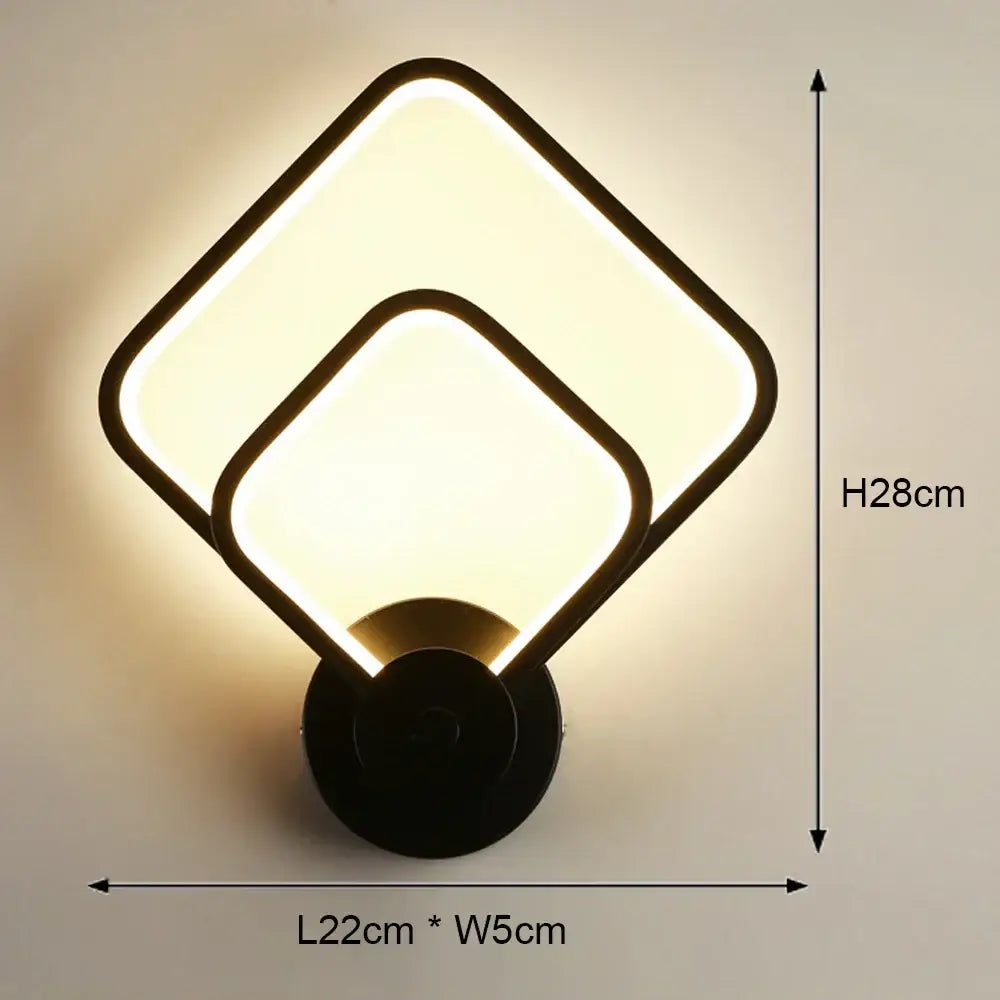 Modern black led wall light with two overlapping square panels emitting warm glow for bedroom geometric sconce