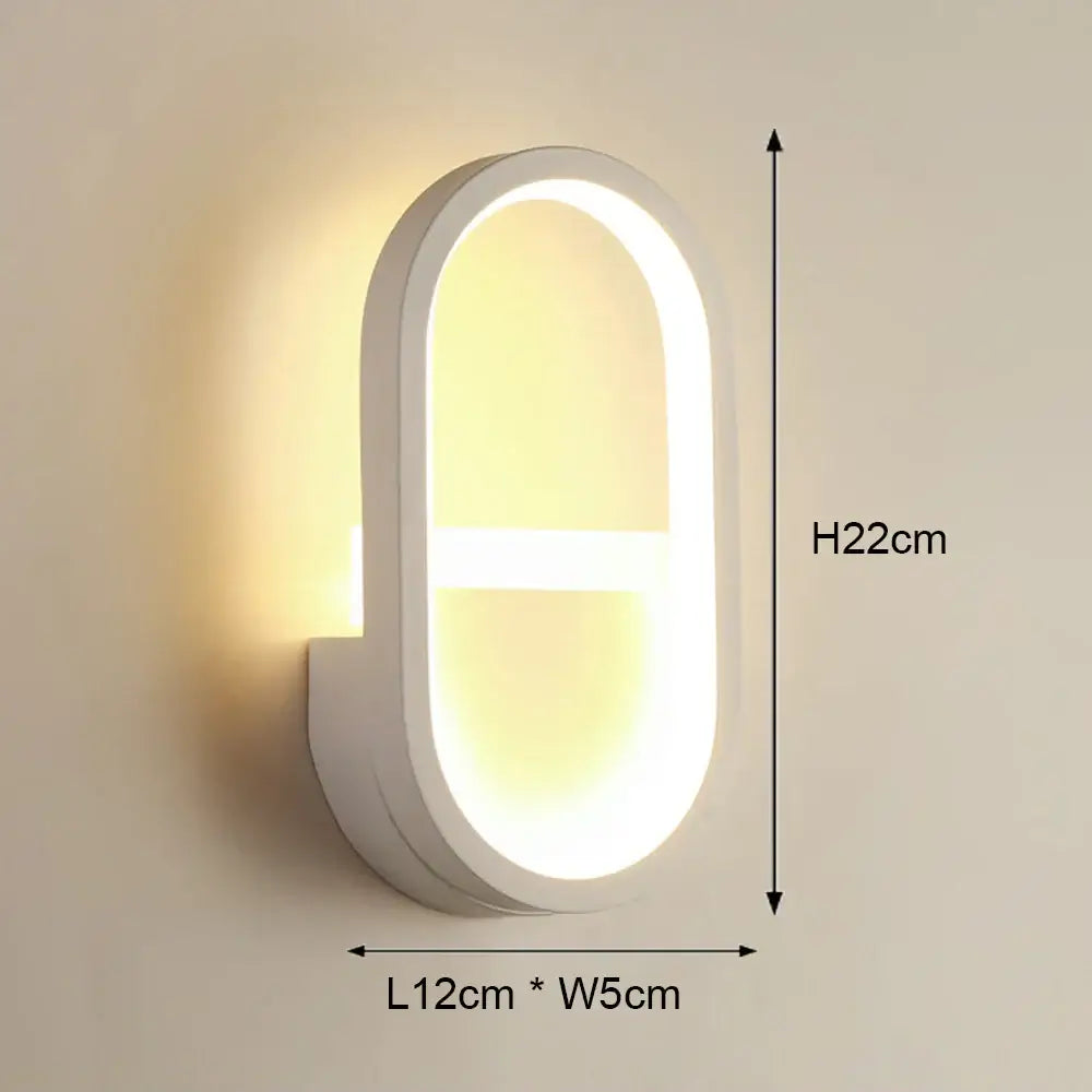 Modern black and white led wall light featuring a white oval-shaped design with warm glowing light for bedroom use