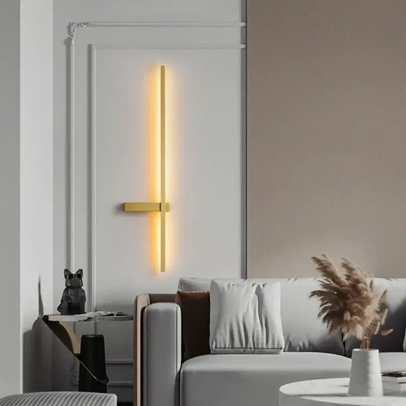 A sleek modern black and gold decorbites led wall light with warm yellow illumination for minimalist living room decor