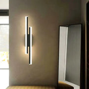 Modern black and white led wall sconce lamp with sleek vertical rectangular design for bedroom lighting