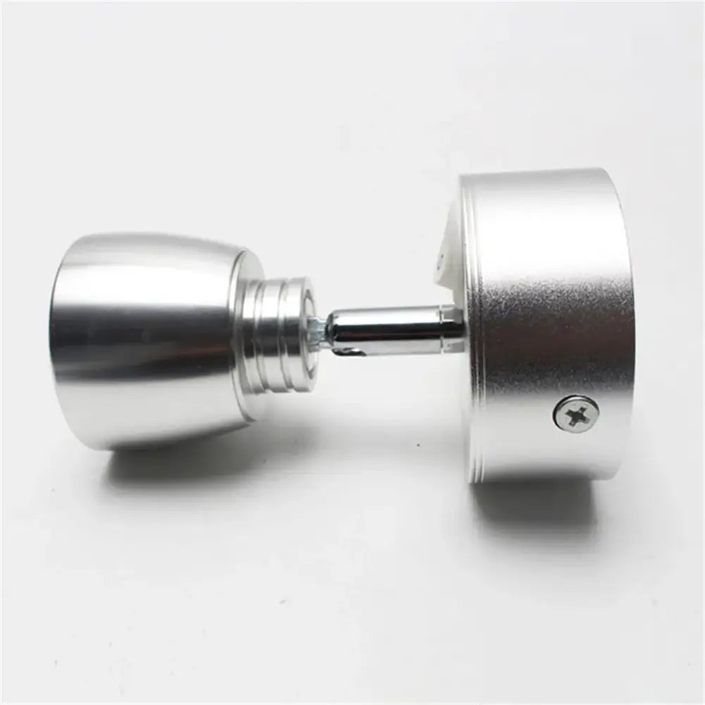Silver metallic dumbbell with sleek cylindrical design and threaded ends beside modern black and white decorbites led wash wall lamp