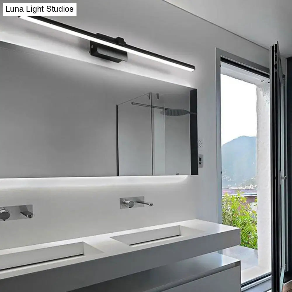Modern black white linear light fixture bathroom wall sconce mounted above a sleek white vanity mirror