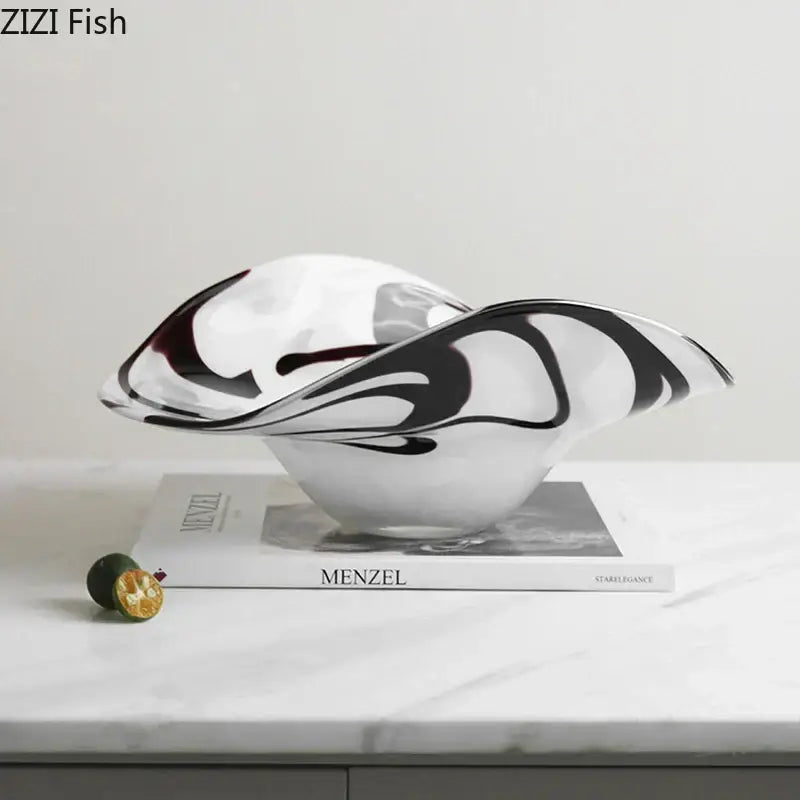 A sleek modern glass fruit plate with black and white marbled abstract swirls for dining room use