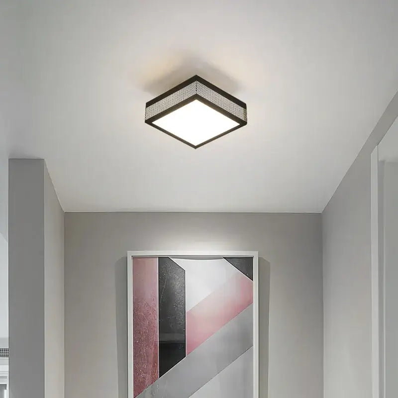 Modern black and white mesh led ceiling light square fixture with black metal frame emitting bright white illumination