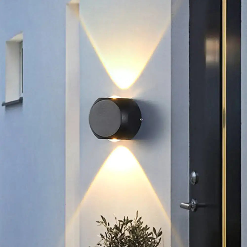 Modern black and white mini cube wall lamp with black cylindrical dual angled lights illuminating living room wall lamp