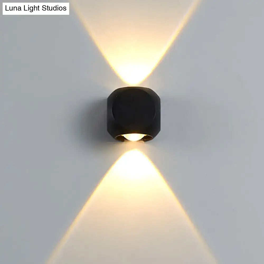 Modern black mini cube wall lamp emitting warm focused light suitable for living room wall sconce lighting