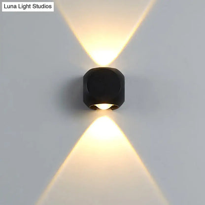 Modern black mini cube wall lamp emitting warm focused light suitable for living room wall sconce lighting