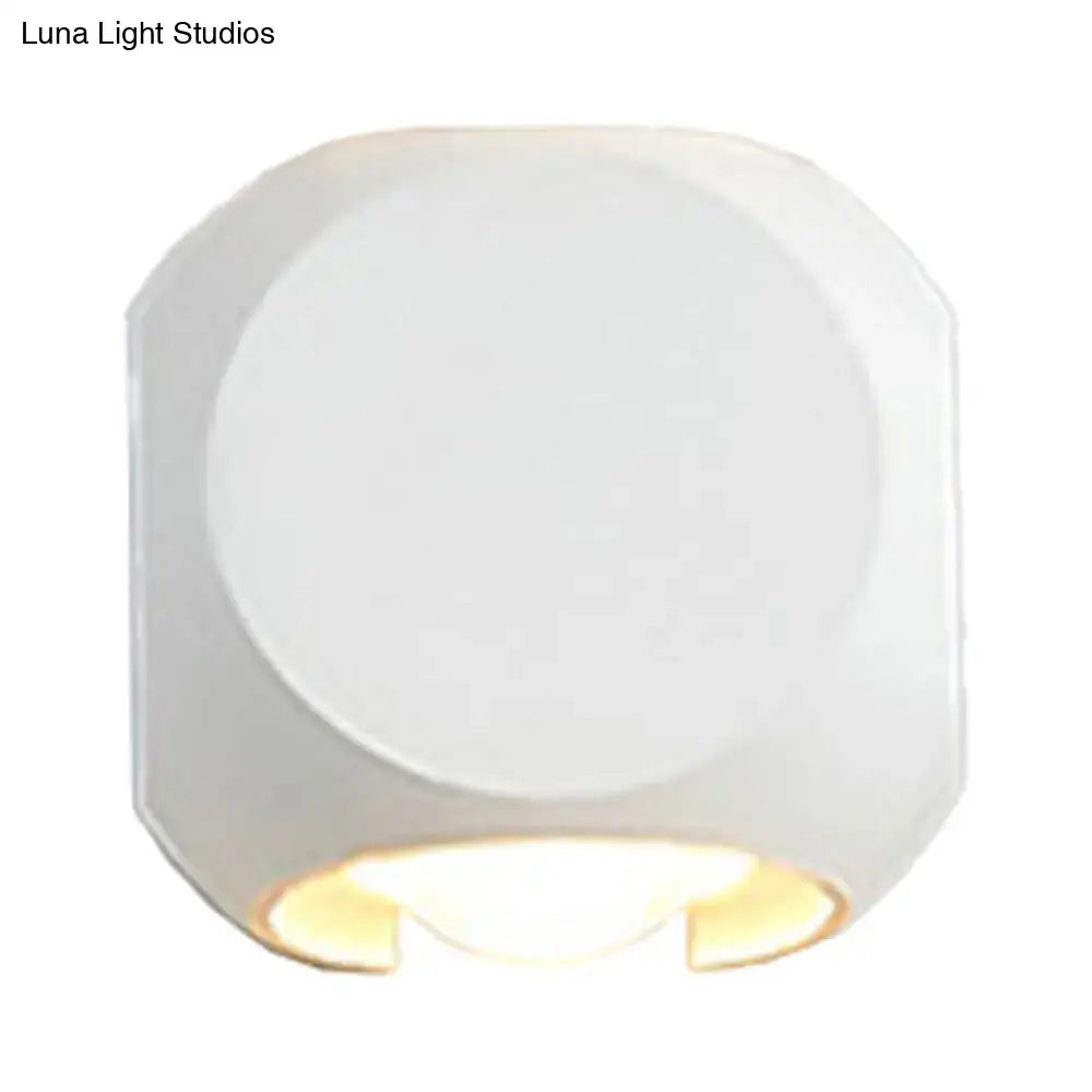 White octagonal mini cube wall lamp with frosted glass diffuser providing warm soft lighting for living room use