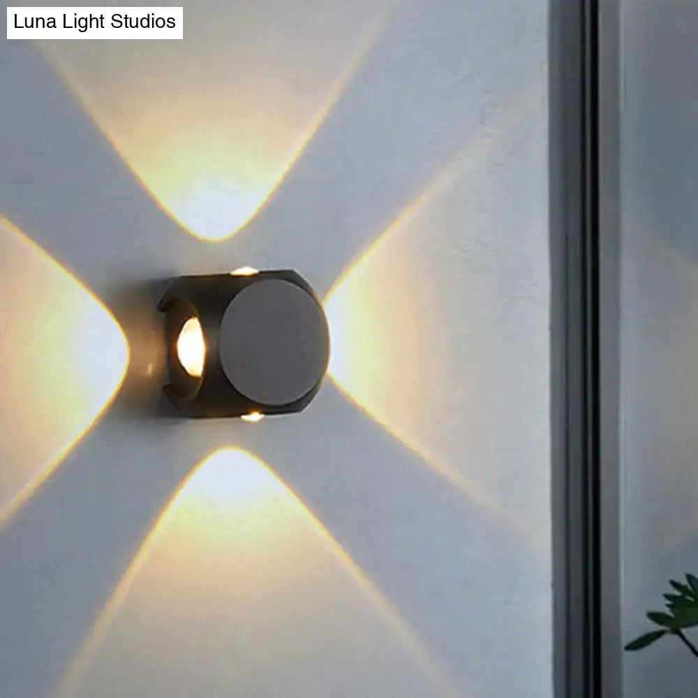 Modern black and white mini cube wall lamp with geometric design casting warm light patterns for living room use