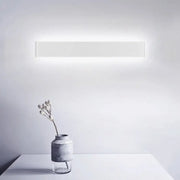 Minimalist white wall lamp with a rectangular metal shade and modern design for living room light fixture use