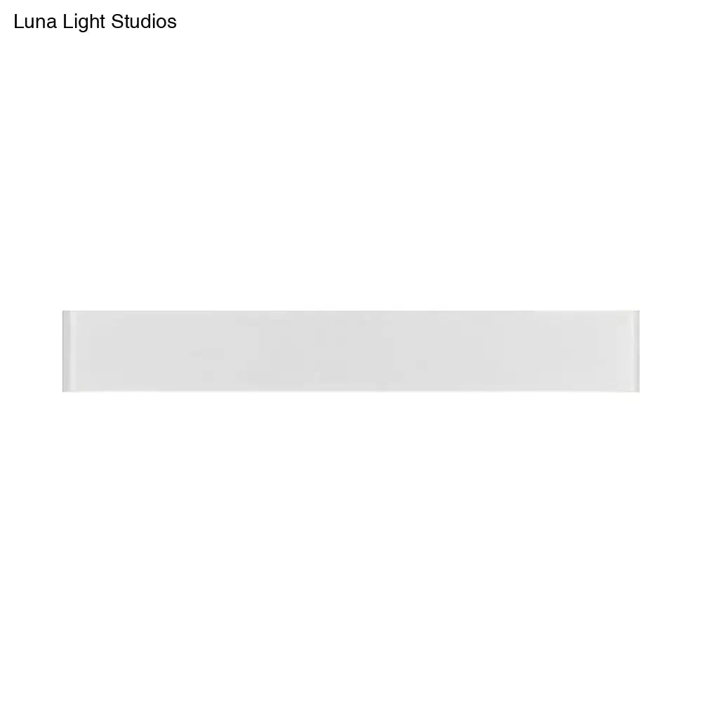A sleek white rectangular wall lamp with a glossy metal shade and softly rounded edges for living room light fixture